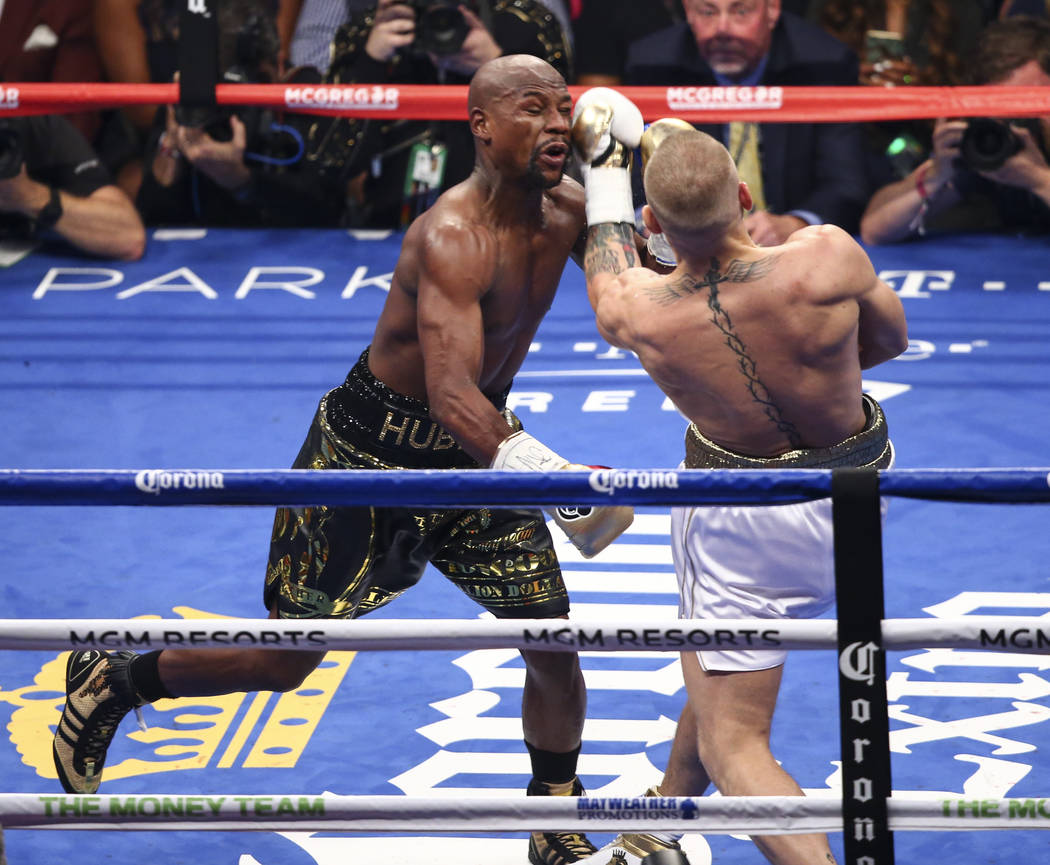 August 26, 2017 - Las Vegas, NEVADA, USA - Floyd Mayweather Jr., (Black and  Gold shorts), fights Conor McGregor (White Shorts)in a super welterweight  boxing match Saturday, Aug. 26, 2017, in Las