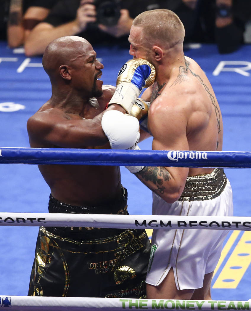 Floyd Mayweather Jr., left, fights Conor McGregor in their super welterweight fight at T-Mobile Arena, Saturday, Aug. 26, 2017, in Las Vegas. Mayweather won via 10th round technical knockout. Chas ...