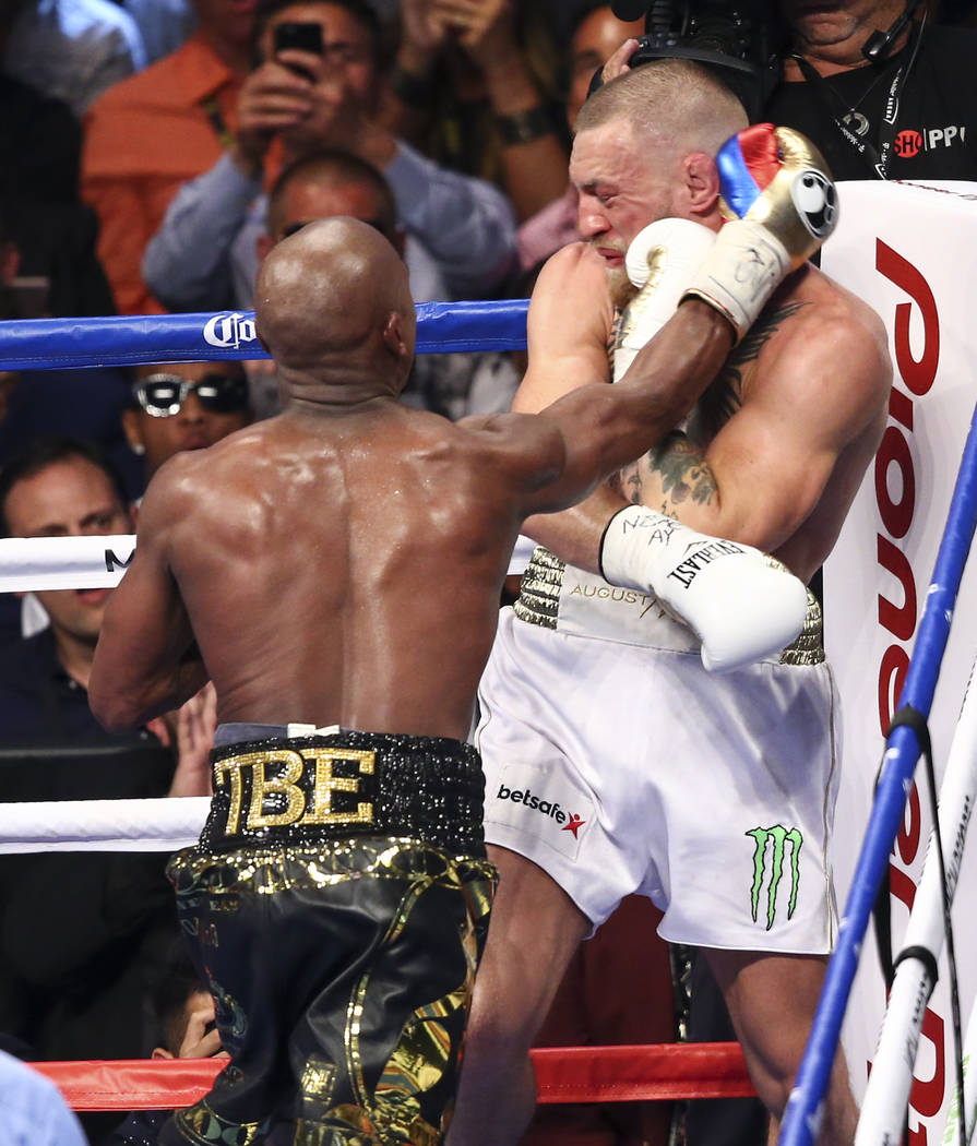 Floyd Mayweather Jr., left, fights Conor McGregor in their super welterweight fight at T-Mobile Arena, Saturday, Aug. 26, 2017, in Las Vegas. Mayweather won via 10th round technical knockout. Chas ...