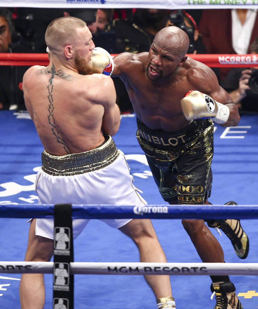Conor McGregor, left, fights Floyd Mayweather Jr. in their super welterweight fight at T-Mobile Arena, Saturday, Aug. 26, 2017, in Las Vegas. Mayweather won via 10th round technical knockout. Chas ...