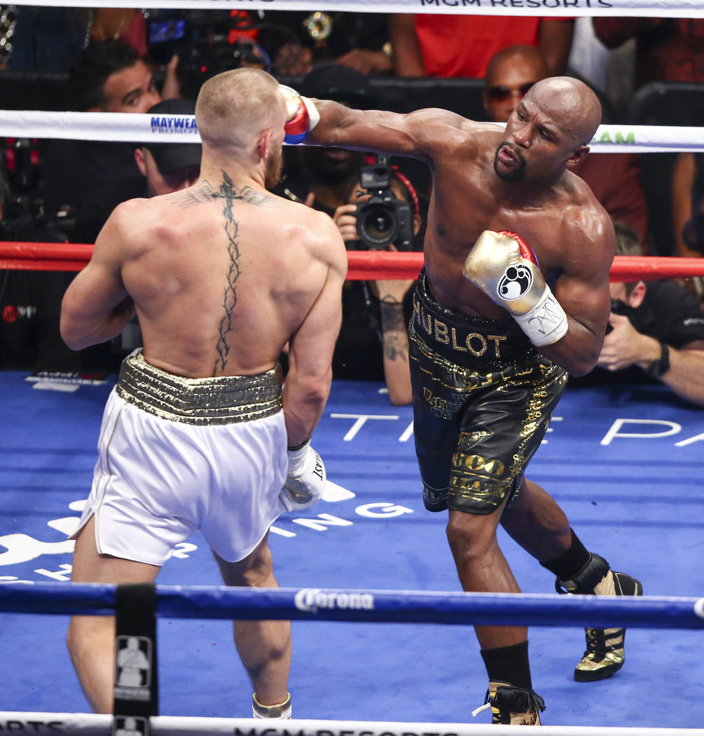 Conor McGregor, left, fights Floyd Mayweather Jr. in their super welterweight fight at T-Mobile Arena, Saturday, Aug. 26, 2017, in Las Vegas. Mayweather won via 10th round technical knockout. Chas ...