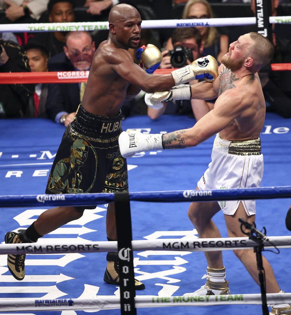Floyd Mayweather Jr., left, fights Conor McGregor in their super welterweight fight at T-Mobile Arena, Saturday, Aug. 26, 2017, in Las Vegas. Mayweather won via 10th round technical knockout. Chas ...