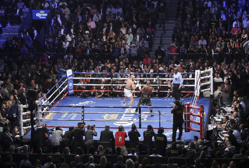 Conor McGregor, left, fights Floyd Mayweather Jr. in their super welterweight fight at T-Mobile Arena, Saturday, Aug. 26, 2017, in Las Vegas. Mayweather won via 10th round technical knockout. Chas ...