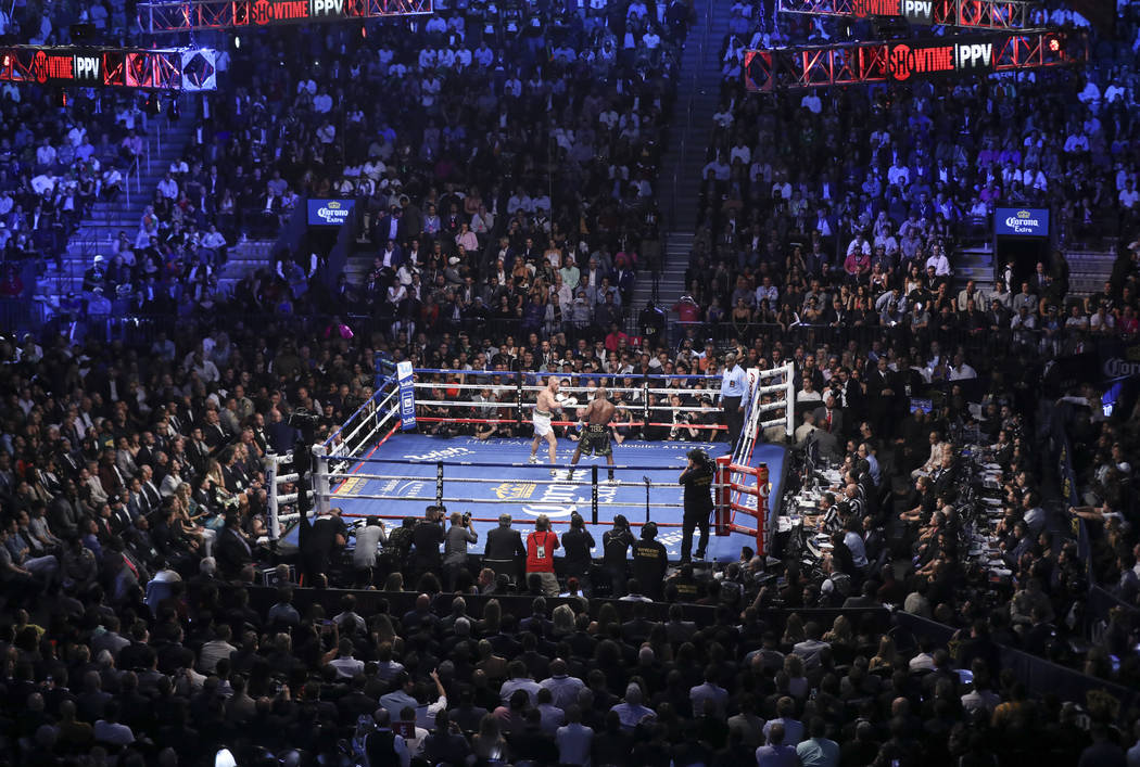 Conor McGregor, left, fights Floyd Mayweather Jr. in their super welterweight fight at T-Mobile Arena, Saturday, Aug. 26, 2017, in Las Vegas. Mayweather won via 10th round technical knockout. Chas ...