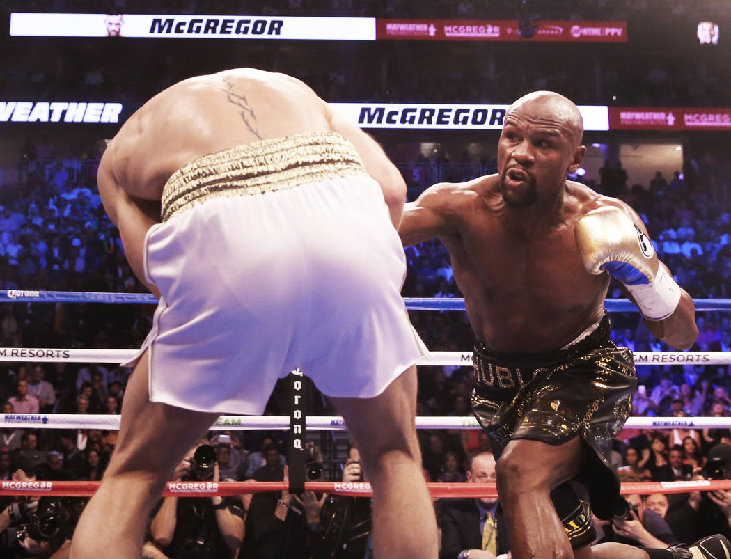 Floyd Mayweather, right, lands a punch against Conor McGregor in the blank round on Saturday, Aug 26, 2017, at T-Mobile Arena, in Las Vegas. Benjamin Hager Las Vegas Review-Journal @benjaminhphoto