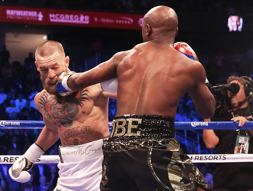 Floyd Mayweather, right, lands a punch against Conor McGregor in the blank round on Saturday, Aug 26, 2017, at T-Mobile Arena, in Las Vegas. Benjamin Hager Las Vegas Review-Journal @benjaminhphoto