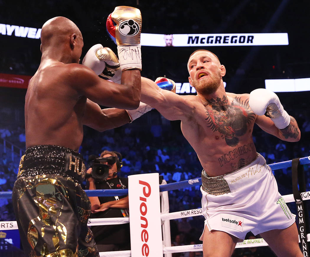 Conor McGregor, right, lands a punch against Floyd Mayweather Jr. in the blank round on Saturday, Aug 26, 2017, at T-Mobile Arena, in Las Vegas. Benjamin Hager Las Vegas Review-Journal @benjaminhphoto