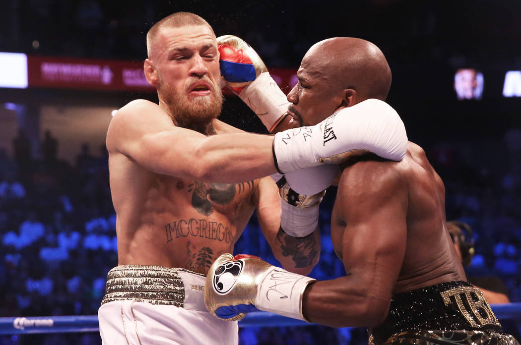 Floyd Mayweather, right, lands a punch against Conor McGregor in the blank round on Saturday, Aug 26, 2017, at T-Mobile Arena, in Las Vegas. Benjamin Hager Las Vegas Review-Journal @benjaminhphoto