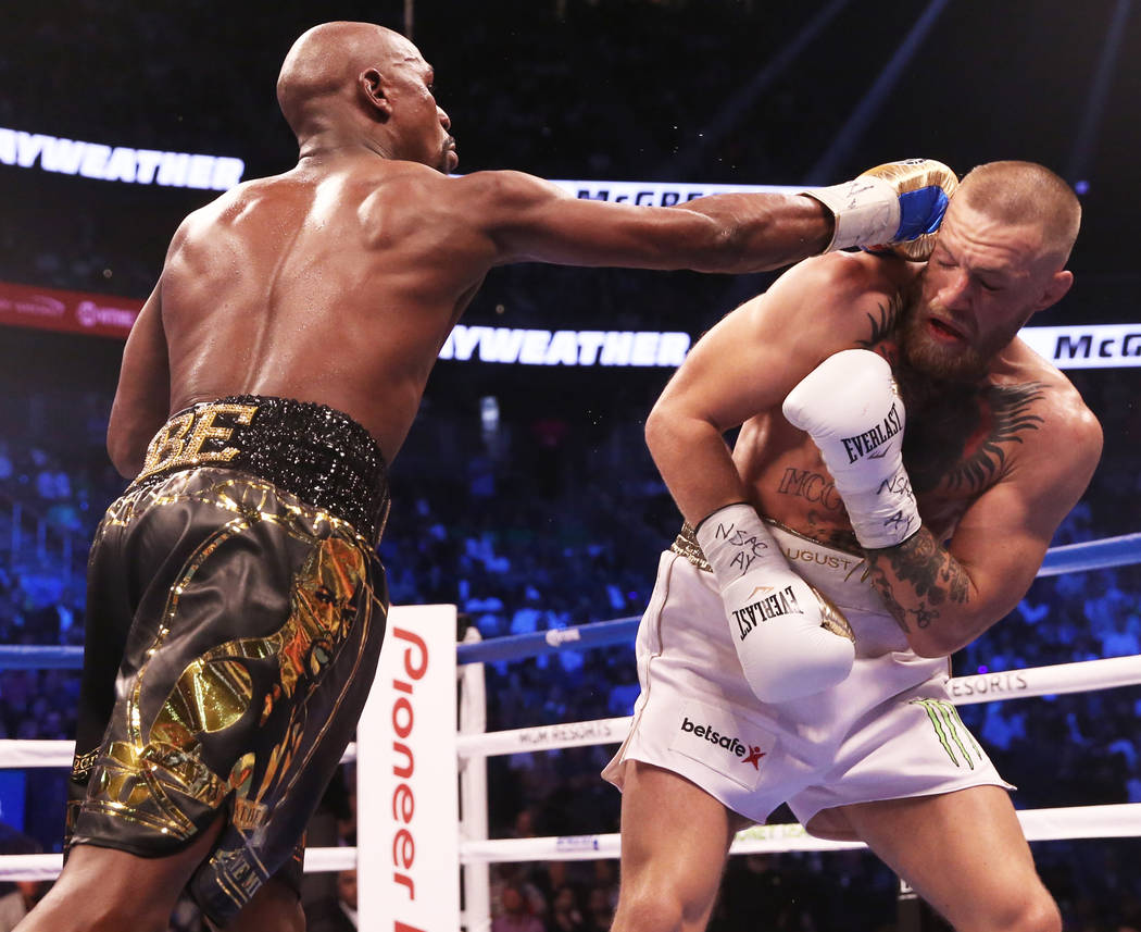 Floyd Mayweather, left, lands a punch against Conor McGregor in the blank round on Saturday, Aug 26, 2017, at T-Mobile Arena, in Las Vegas. Benjamin Hager Las Vegas Review-Journal @benjaminhphoto