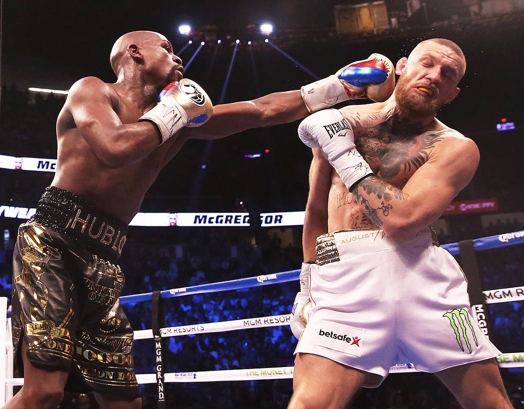 Floyd Mayweather, left, lands a punch against Conor McGregor in the blank round on Saturday, Aug 26, 2017, at T-Mobile Arena, in Las Vegas. Benjamin Hager Las Vegas Review-Journal @benjaminhphoto