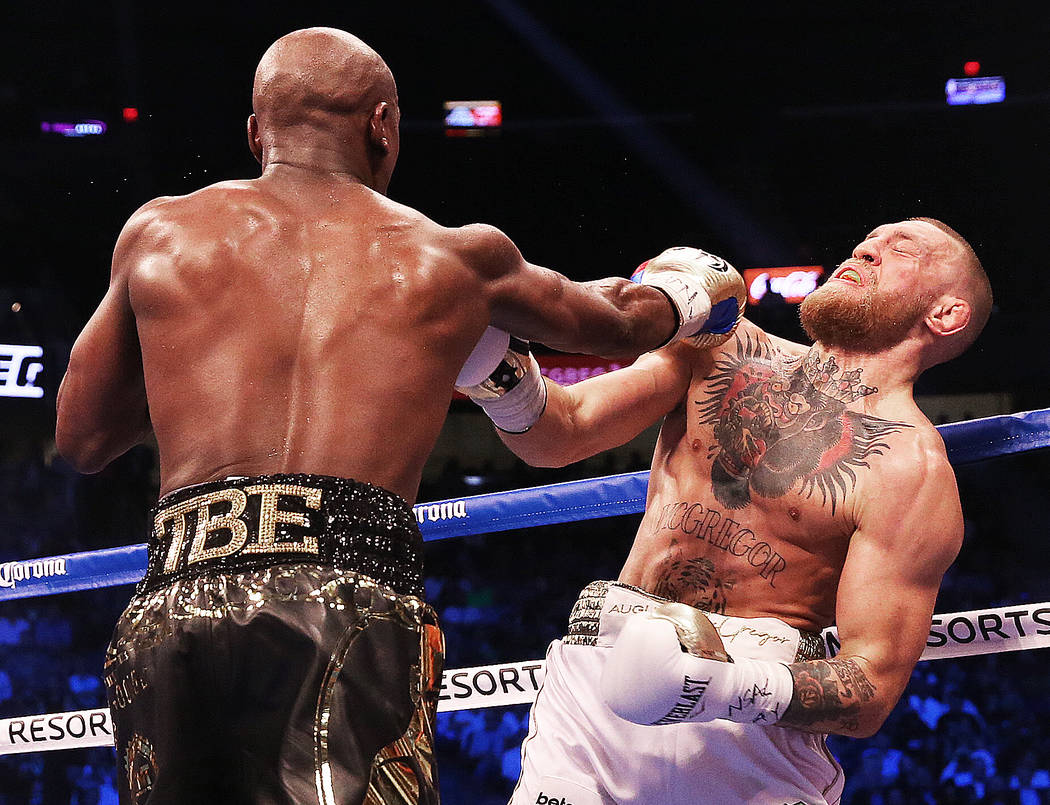 Floyd Mayweather, left, lands a punch against Conor McGregor in the blank round on Saturday, Aug 26, 2017, at T-Mobile Arena, in Las Vegas. Benjamin Hager Las Vegas Review-Journal @benjaminhphoto