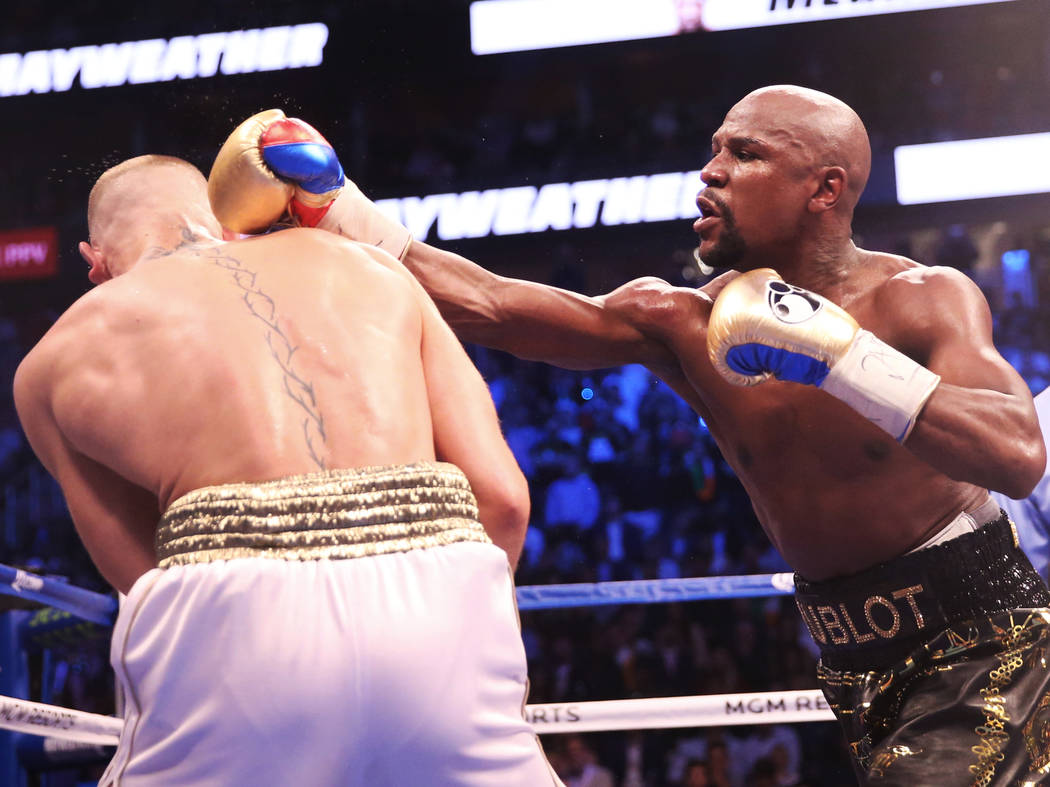 Floyd Mayweather, right, lands a punch against Conor McGregor in the blank round on Saturday, Aug 26, 2017, at T-Mobile Arena, in Las Vegas. Benjamin Hager Las Vegas Review-Journal @benjaminhphoto
