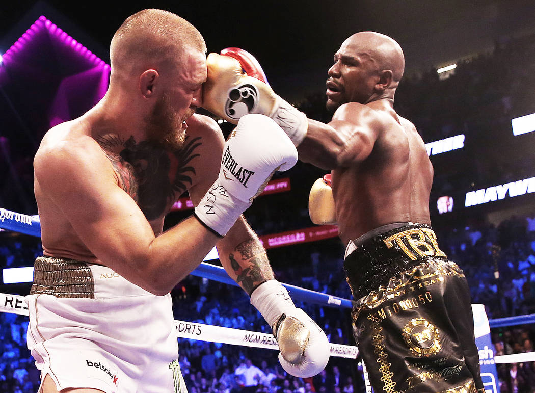 Floyd Mayweather, right, lands a punch against Conor McGregor in the blank round on Saturday, Aug 26, 2017, at T-Mobile Arena, in Las Vegas. Benjamin Hager Las Vegas Review-Journal @benjaminhphoto