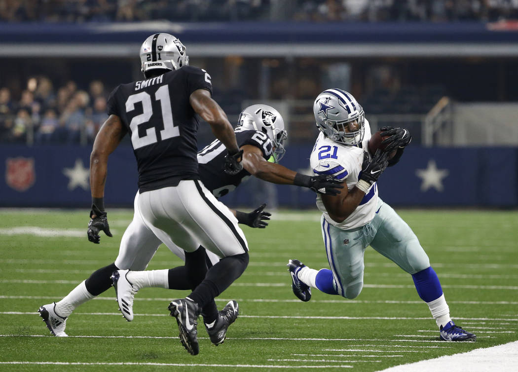 Oakland Raiders cornerback Sean Smith (21) and Obi Melifonwu (20) chase Dallas Cowboys running back Ezekiel Elliott (21) out of bounds in the first half of a preseason NFL football game, Saturday, ...