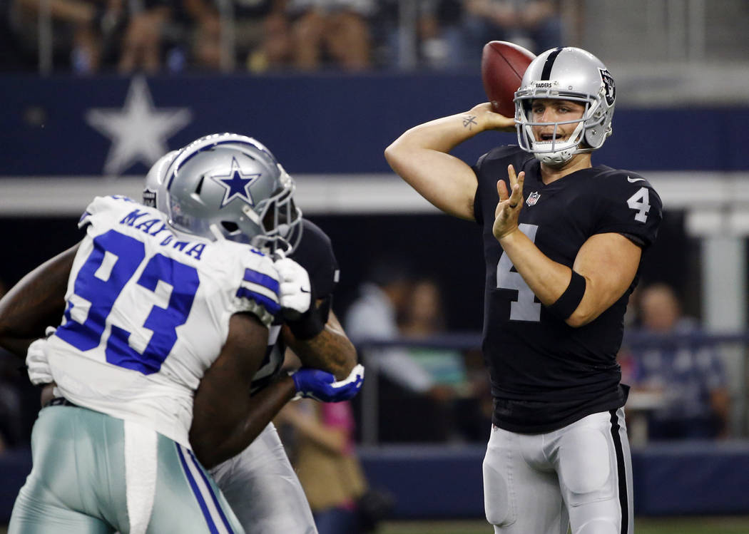 Dallas Cowboys defensive end Benson Mayowa (93) pressures as Oakland Raiders quarterback Derek Carr (4) throws a pass in the first half of a preseason NFL football game, Saturday, Aug. 26, 2017, i ...