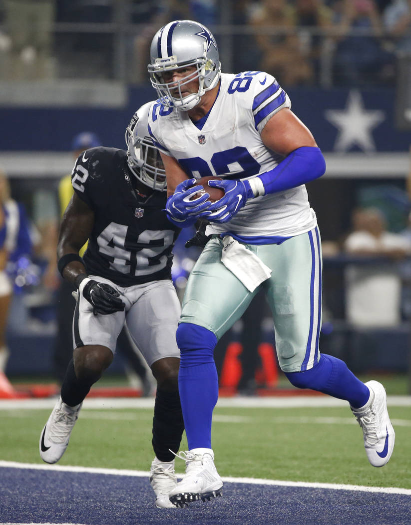Dallas Cowboys tight end Jason Witten (82) catches a pass for a touchdown in front of Oakland Raiders safety Karl Joseph (42) in the first half of a preseason NFL football game, Saturday, Aug. 26, ...