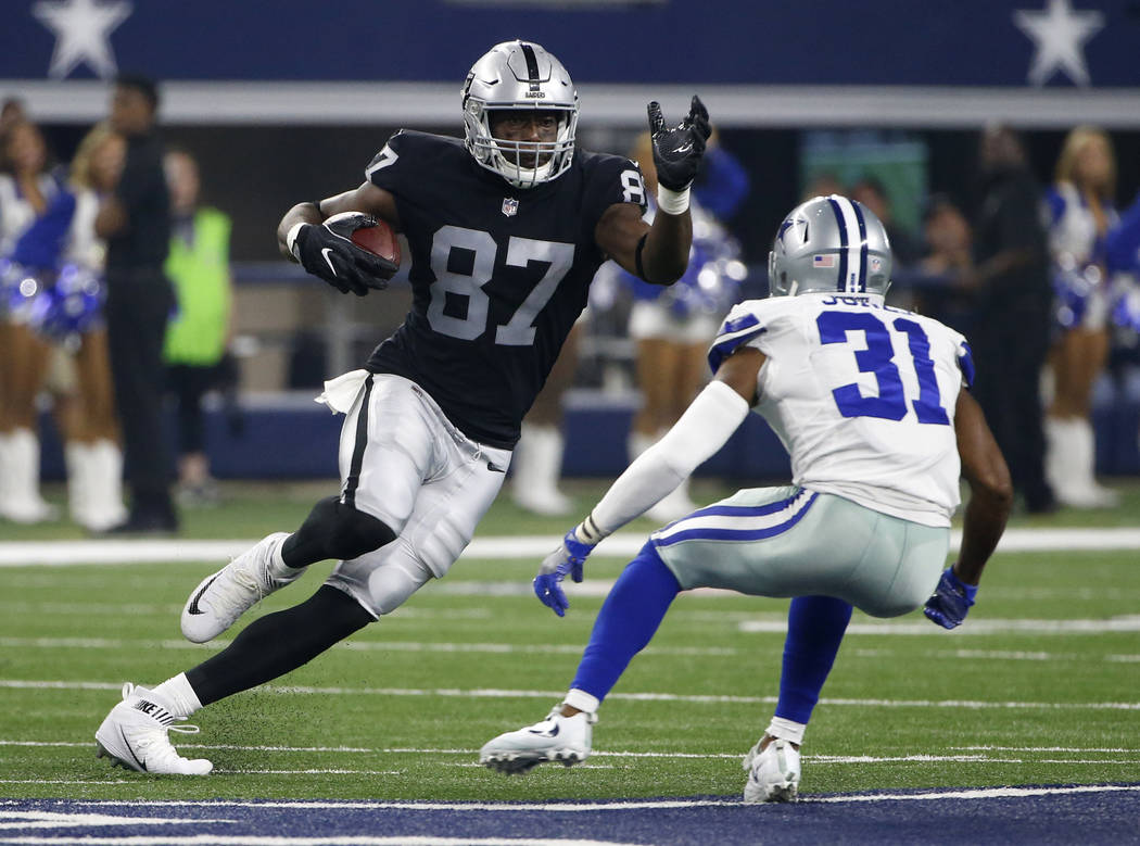 Oakland Raiders tight end Jared Cook (87) looks for running room after catching a pass against Dallas Cowboys safety Byron Jones (31) in the first half of a preseason NFL football game, Saturday,  ...