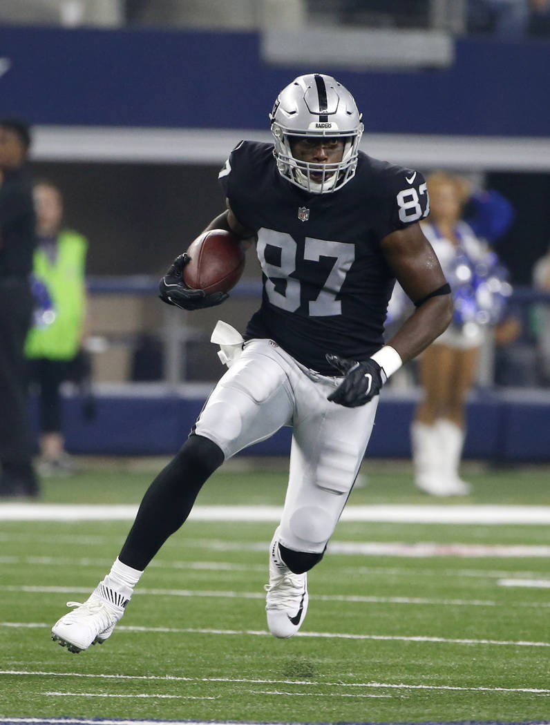 Oakland Raiders tight end Jared Cook (87) finds running room after catching a pass in the first half of a preseason NFL football game against the Dallas Cowboys on Saturday, Aug. 26, 2017, in Arli ...
