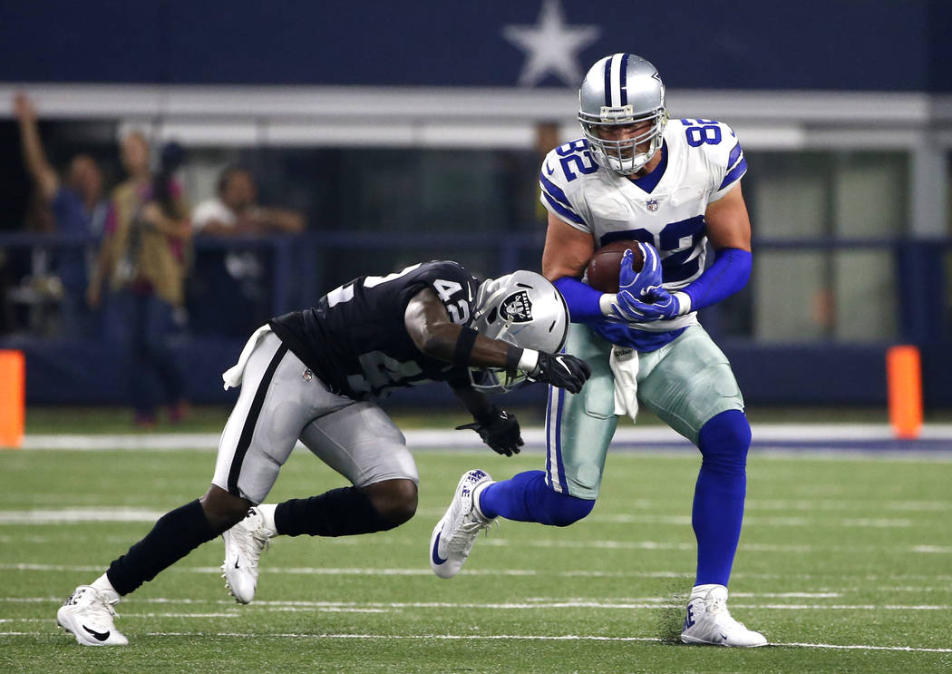 Oakland Raiders safety Karl Joseph (42) attempts to stop Dallas Cowboys tight end Jason Witten (82) as Witten gains yardage after a catch in the first half of a preseason NFL football game, Saturd ...