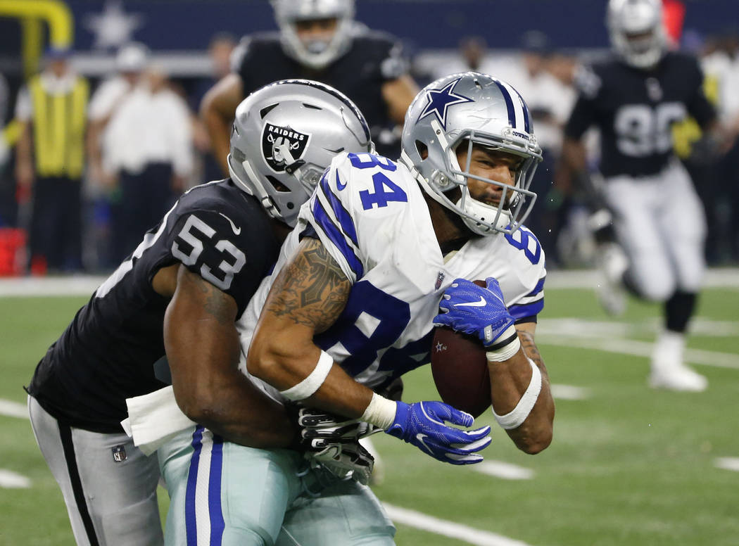 Oakland Raiders linebacker Jelani Jenkins (53) attempts the stop as Dallas Cowboys tight end James Hanna (84) fights for extra yardage after catching a pass in the second half of a preseason NFL f ...