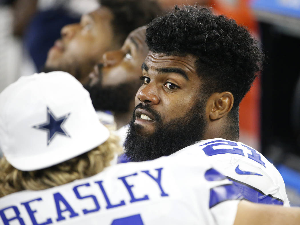 Dallas Cowboys' Cole Beasley (11) talks with running back Ezekiel Elliott, right, on the sideline in the second half of a preseason NFL football game against the Oakland Raiders on Saturday, Aug. ...