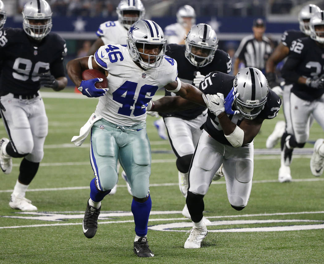 Dallas Cowboys running back Alfred Morris (46) runs the ball fighting off a tackle attempt by Oakland Raiders safety Rickey Jefferson (25) in the second half of a preseason NFL football game, Satu ...