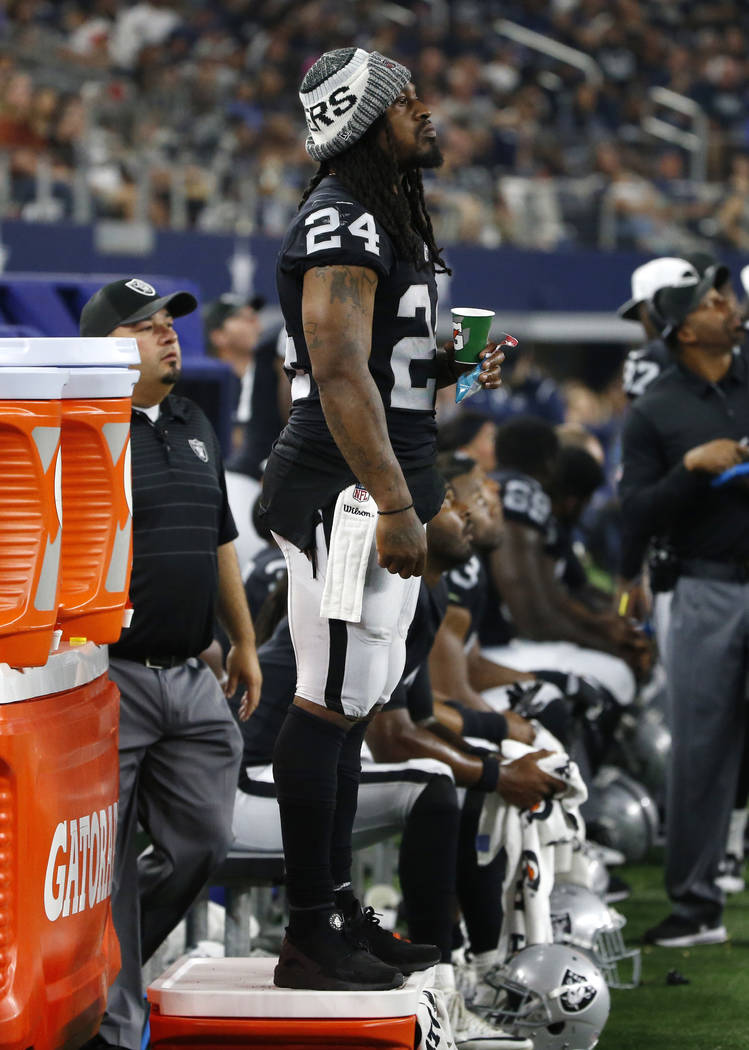 Oakland Raiders running back Marshawn Lynch (24) watches play from the sideline in the second half of a preseason NFL football game against the Dallas Cowboys on Saturday, Aug. 26, 2017, in Arling ...
