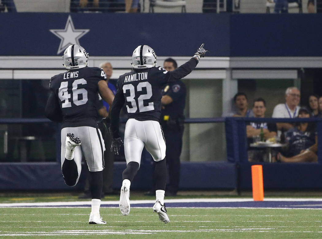 Oakland Raiders' LaTroy Lewis (46) and Antonio Hamilton (32) celebrate an interception by Lewis he ran back for a touchdown against the Dallas Cowboys in the second half of a preseason NFL footbal ...