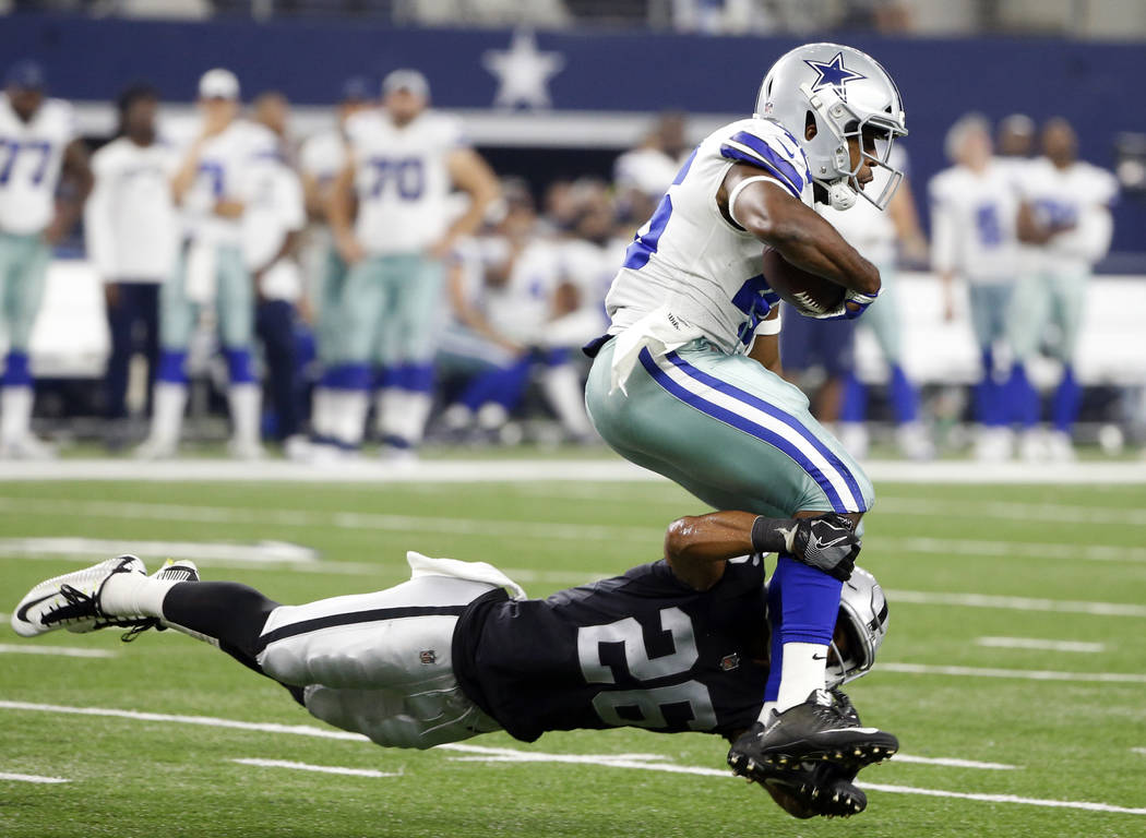 Oakland Raiders safety Shalom Luani (26) dives to make the stop against Dallas Cowboys running back Alfred Morris in the second half of a preseason NFL football game, Saturday, Aug. 26, 2017, in A ...
