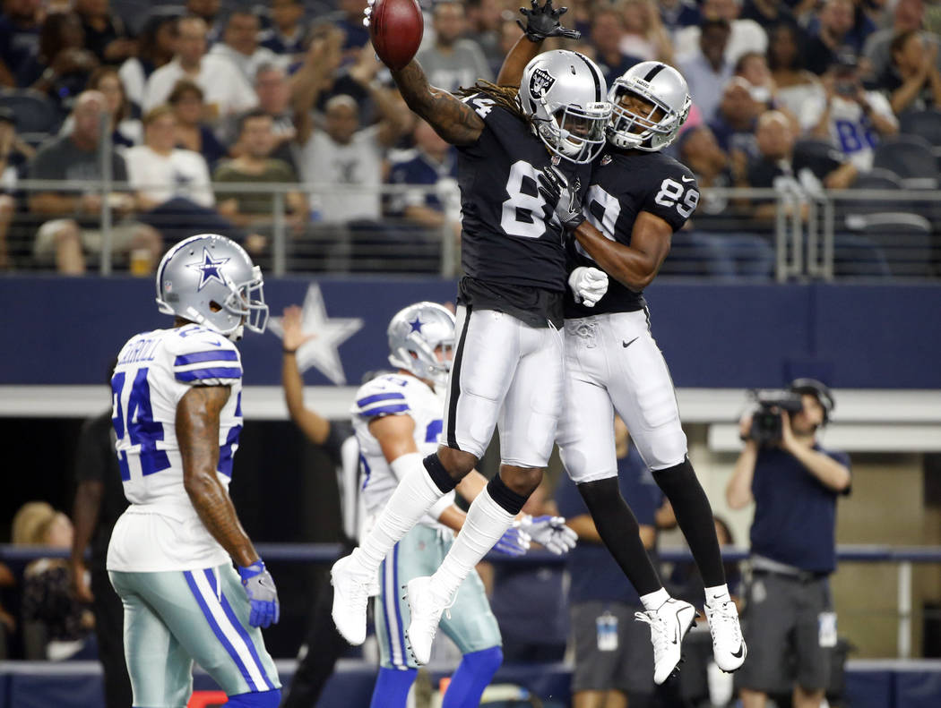 Oakland Raiders wide receiver Amari Cooper (89) and Cordarrelle Patterson, center, celebrate a touchdown catch by Patterson in front of Dallas Cowboys cornerback Nolan Carroll II (24) in the first ...