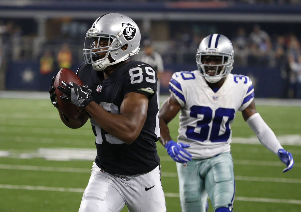 Oakland Raiders wide receiver Amari Cooper catches a pass in front of Dallas Cowboys cornerback Anthony Brown (30) and head sot the end zone for a touchdown in the first half of a preseason NFL fo ...
