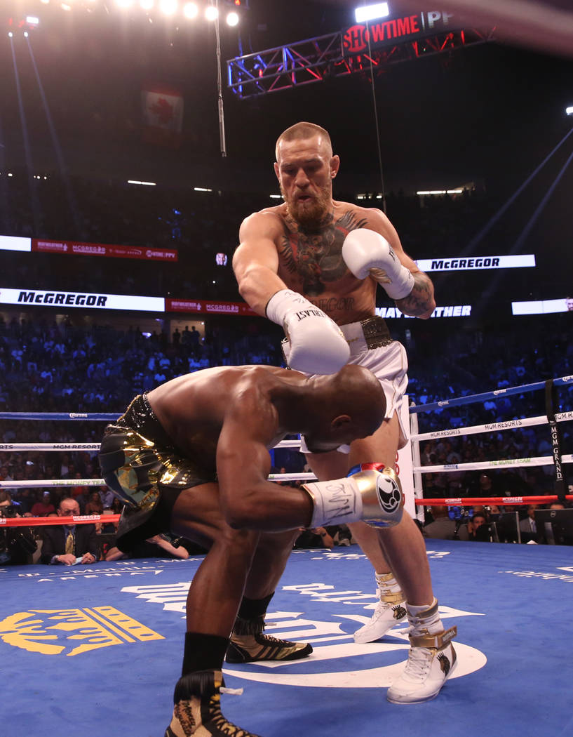 Conor McGregor takes a swing at Floyd Mayweather Jr. during the first round of their fight at T-Mobile Arena, Saturday, Aug. 26, 2017, in Las Vegas. Benjamin Hager Las Vegas Review-Journal