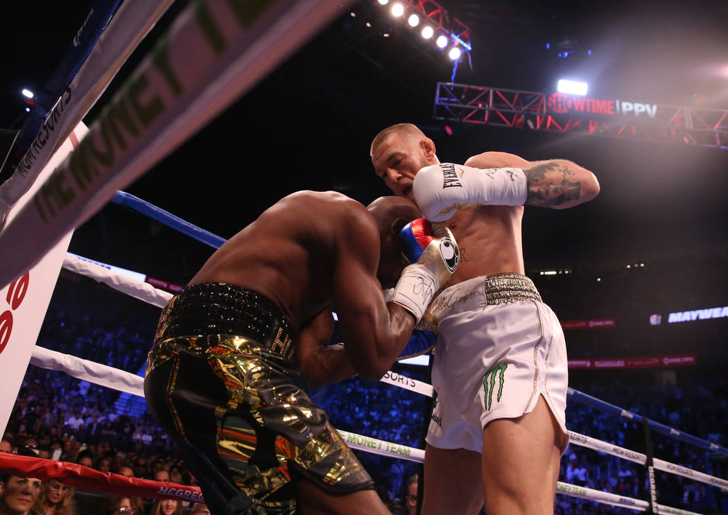 Floyd Mayweather Jr., left, blocks a shot from Conor McGregor during the first round of their fight at T-Mobile Arena, Saturday, Aug. 26, 2017, in Las Vegas. Benjamin Hager Las Vegas Review-Journal