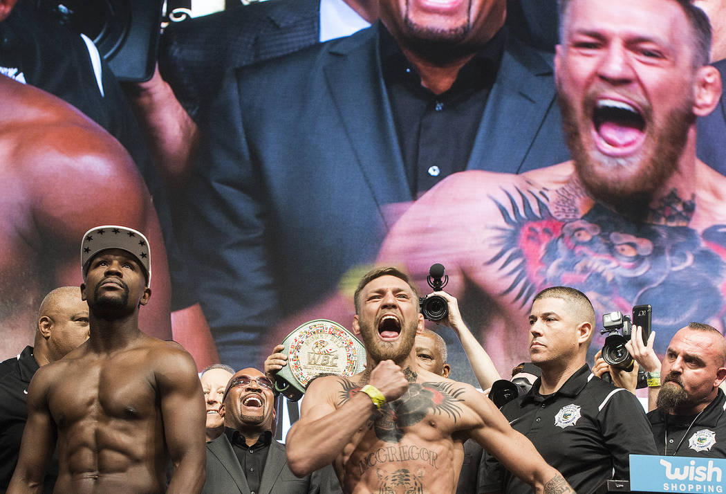 Conor McGregor, right, and Floyd Mayweather Jr. pump up the crowd during weigh-ins on Friday, Aug 25, 2017, at T-Mobile Arena, in Las Vegas. Benjamin Hager Las Vegas Review-Journal @benjaminhphoto