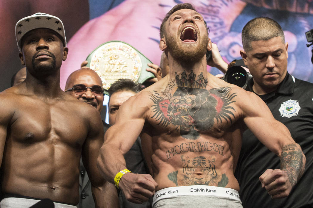 Conor McGregor, right, and Floyd Mayweather Jr. pump up the crowd during weigh-ins on Friday, Aug 25, 2017, at T-Mobile Arena, in Las Vegas. Benjamin Hager Las Vegas Review-Journal @benjaminhphoto