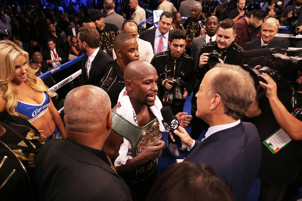 Floyd Mayweather, middle, answers questions from the media after his TKO victory over Conor McGregor in the blank round on Saturday, Aug 26, 2017, at T-Mobile Arena, in Las Vegas. Benjamin Hager L ...