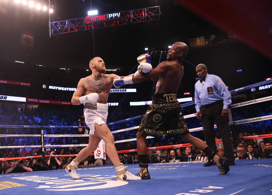 Conor McGregor takes a swing at Floyd Mayweather Jr. during the first round of their fight at T-Mobile Arena, Saturday, Aug. 26, 2017, in Las Vegas. Benjamin Hager Las Vegas Review-Journal