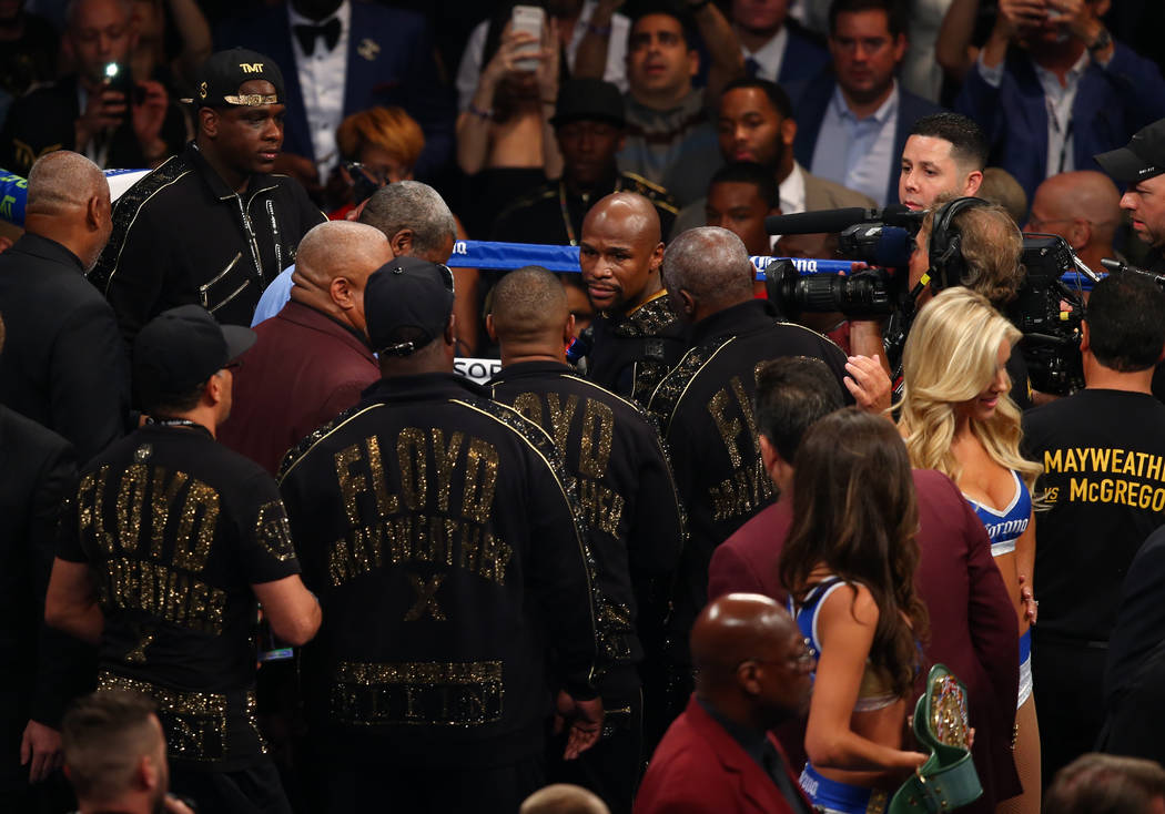 Floyd Mayweather Jr., center, enters the ring before his fight against Conor McGregor at T-Mobile Arena, Saturday, Aug. 26, 2017, in Las Vegas. Chase Stevens Las Vegas Review-Journal