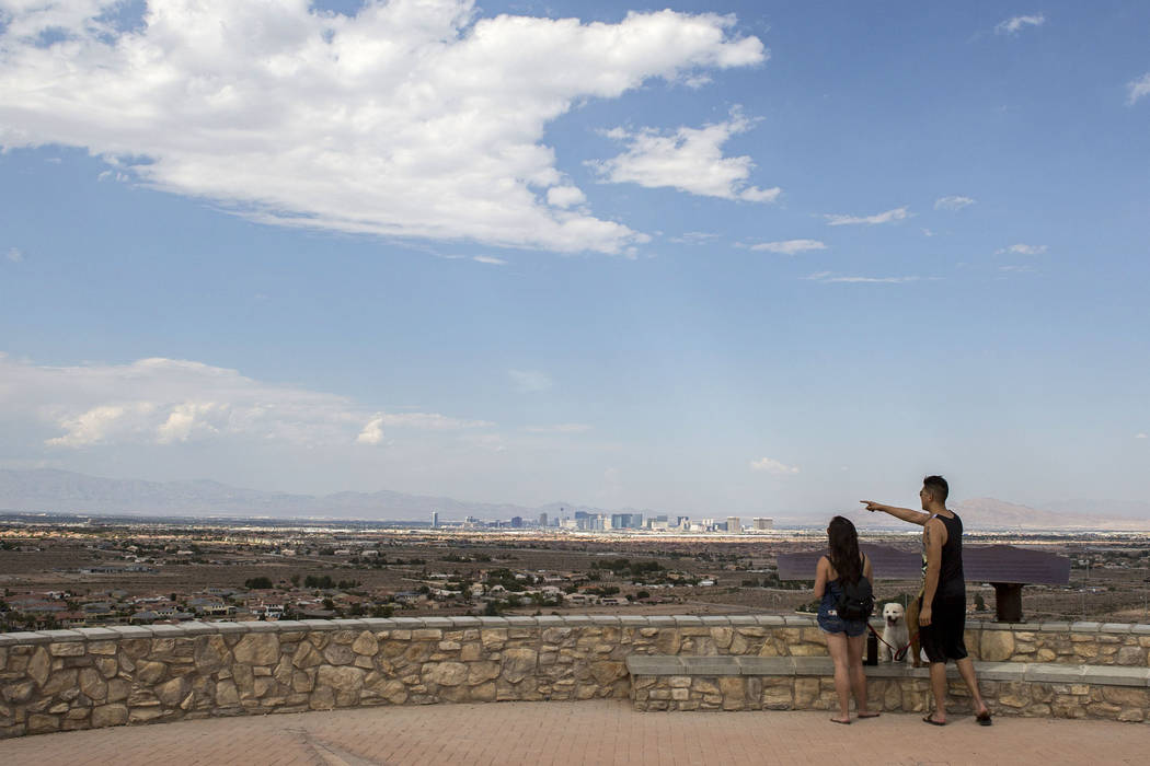 Eric and Rose Chung take in the views at Exploration Peak Park with their dogs Scooby and Furrawrri on Sunday, Aug. 6, 2017. The Las Vegas Valley can expect dry conditions and high temperatures in ...