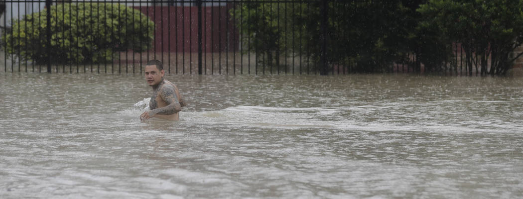 A man wades through floodwaters from Tropical Storm Harvey Sunday, Aug. 27, 2017, in Houston, Texas. (David J. Phillip/AP)