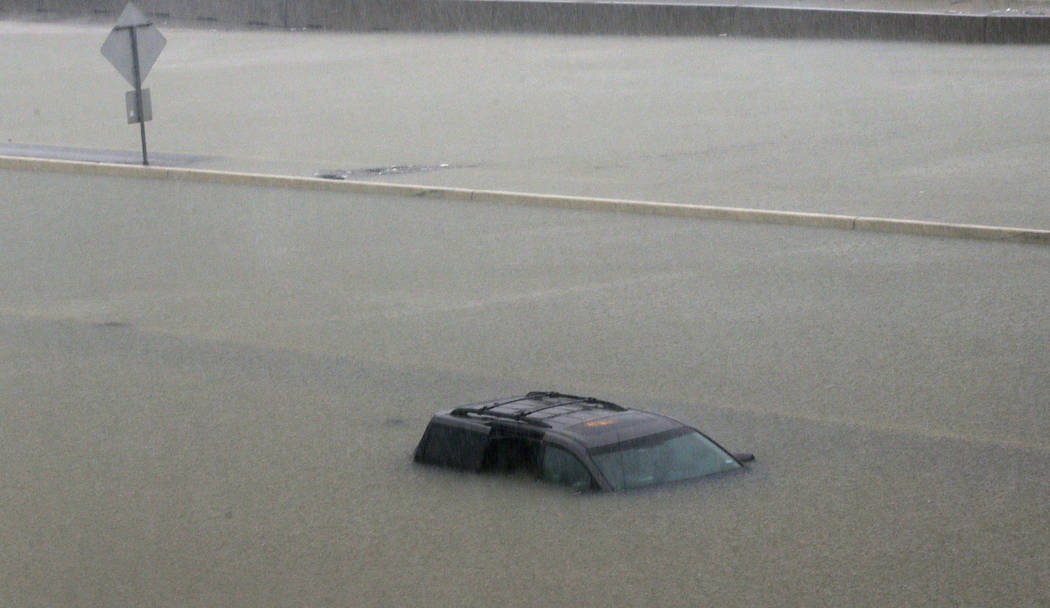 An abandoned vehicle sits in flood waters on the I-10 highway in Houston, Texas, Sunday, Aug. 27, 2017. (LM Otero/AP)