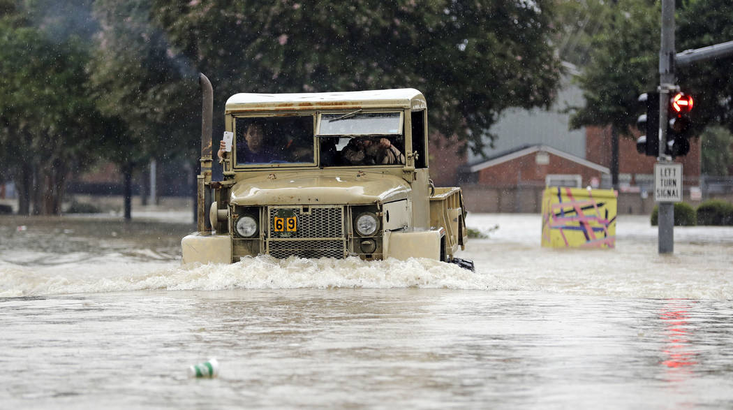 A truck pushes through floodwaters from Tropical Storm Harvey on Sunday, Aug. 27, 2017, in Houston, Texas. (David J. Phillip/AP)
