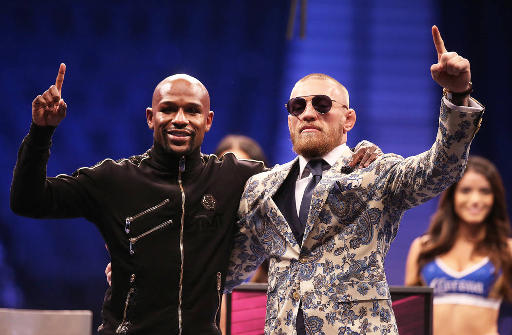 Floyd Mayweather, left, and Conor McGregor salute the crowd at the post fight press conference on Saturday, Aug 26, 2017, at T-Mobile Arena, in Las Vegas. Benjamin Hager Las Vegas Review-Journal @ ...