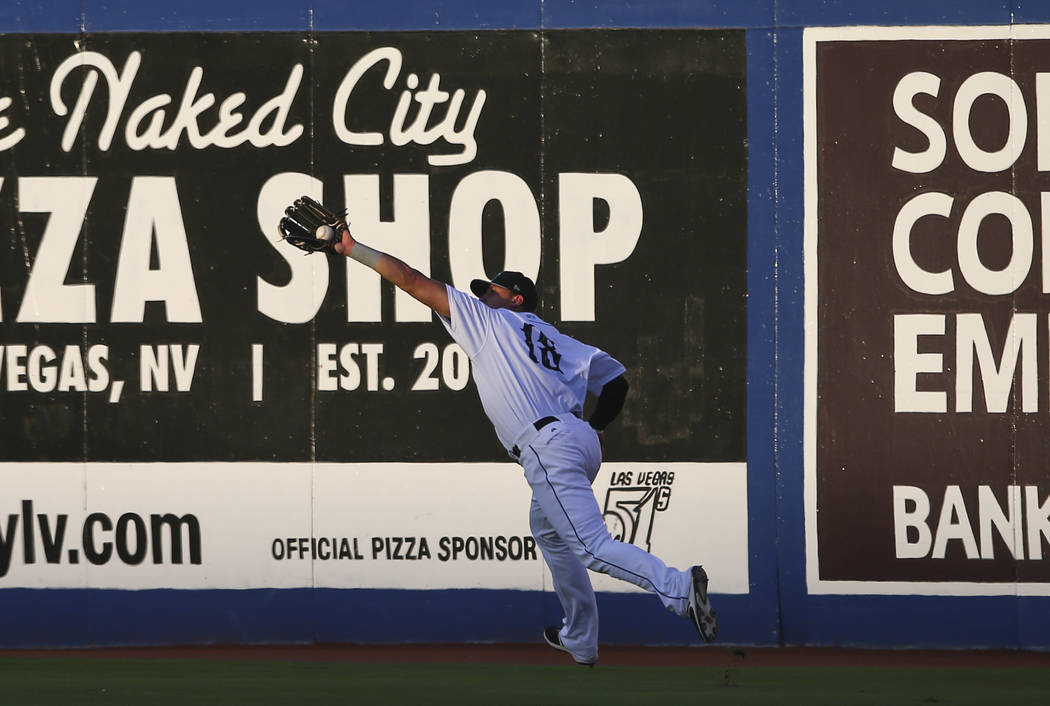 Las Vegas 51s' Travis Taijeron (18) catches a fly ball from the Colorado Springs Sky Sox during the debut of the &quot;Reyes de Plata&quot; (Silver Kings), part of a new Minor League Baseb ...