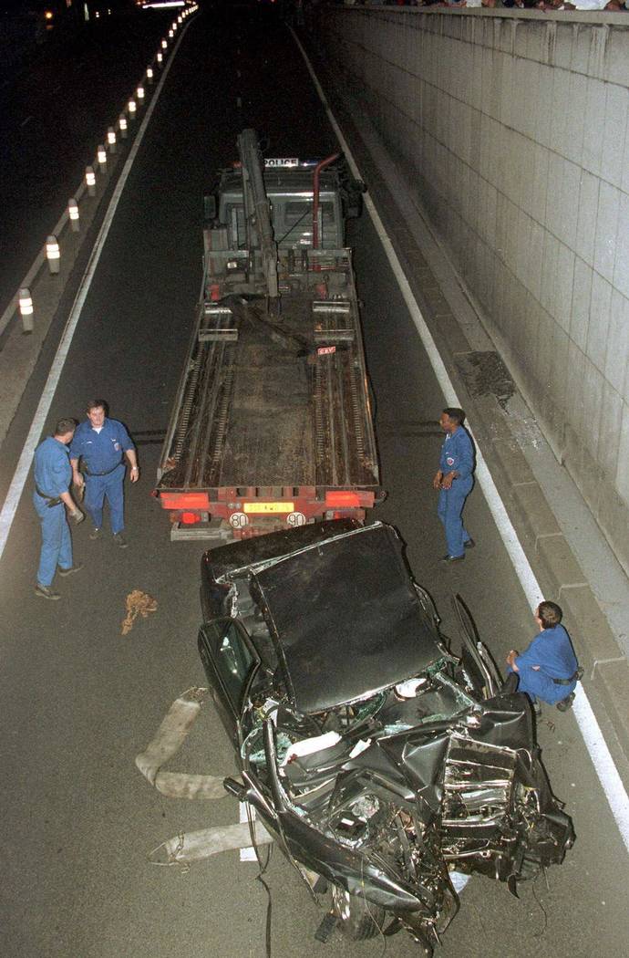 Workers prepare to take away the car in which Diana, Princess of Wales, died in Paris, in a car crash that also killed her boyfriend, Dodi Fayed, and the chauffeur in August 1997. (AP Photo/Jerome ...