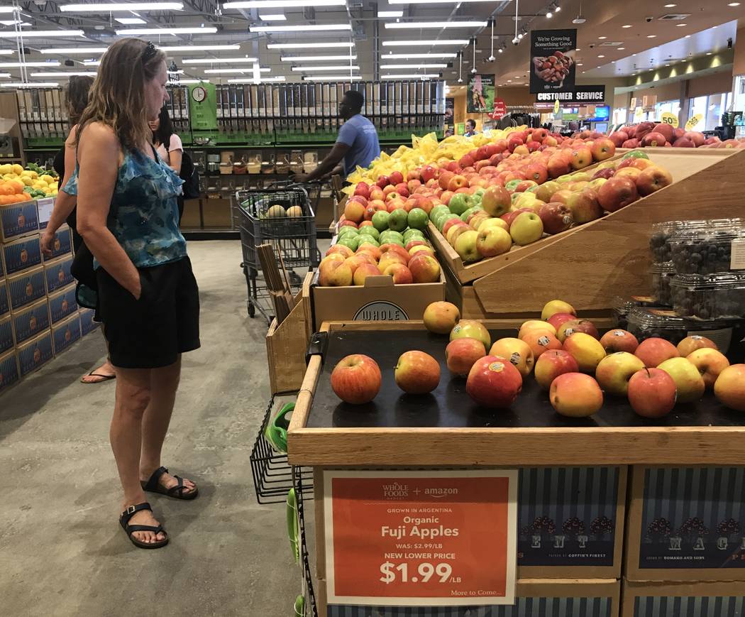 Customers in the produce section at the Summerlin Whole Foods Market on Monday, Aug. 28, 2017, in Las Vegas. Amazon kicked off its first day as the owner of Whole Foods by slashing prices and addi ...