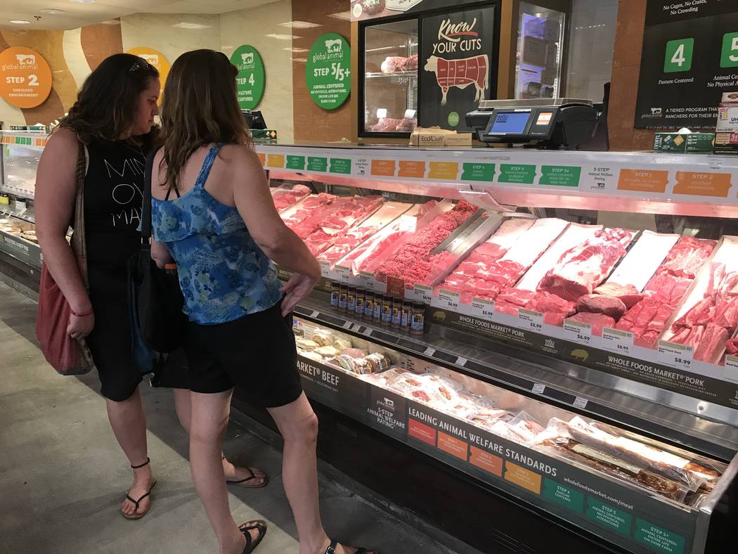 Customers in the meat and poultry department at the Summerlin Whole Foods Market on Monday, Aug. 28, 2017, in Las Vegas. Amazon kicked off its first day as the owner of Whole Foods by slashing pri ...