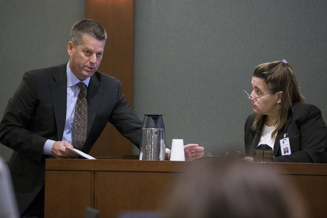 Peter S. Christiansen, left, attorney for Assuan Martinez, a father charged with murder in the death of his infant son, shows evidence to Clark County Medical Examiner Lisa Gavin during his client ...