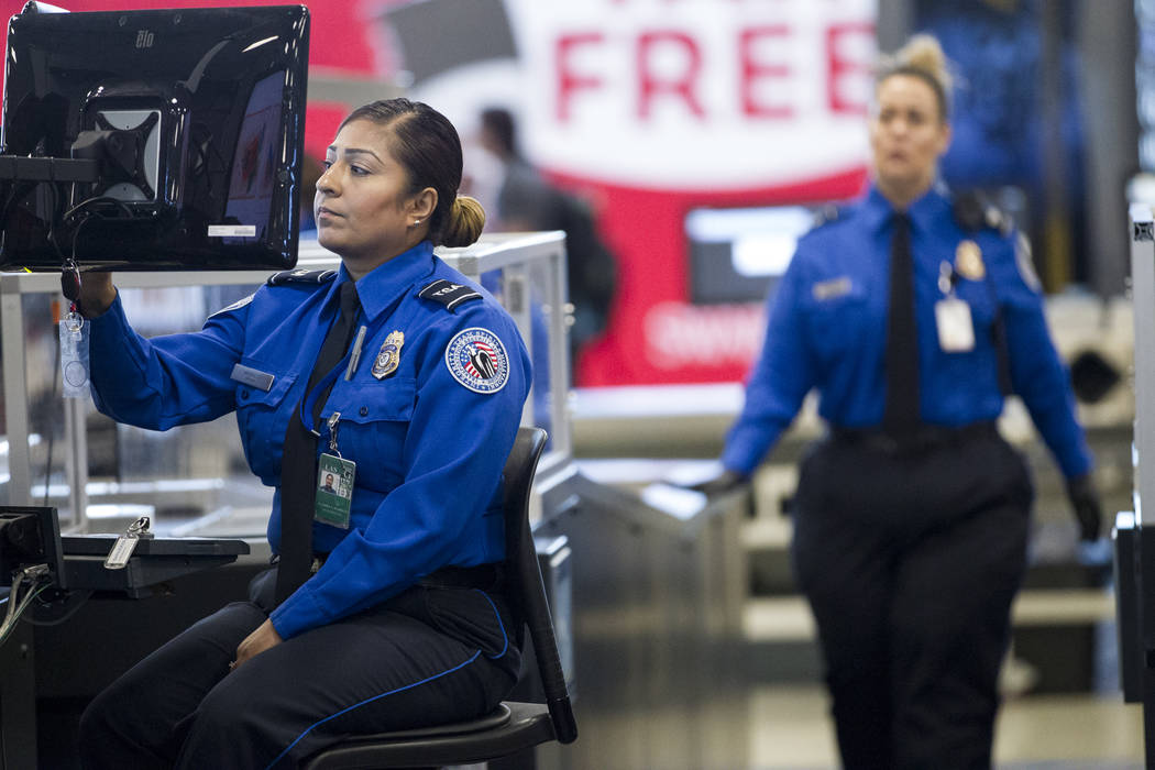 Transportation Security Administration agent Lladira Madriles monitors passenger's property entering one of the new automated screening lanes at McCarran International Airport Terminal 1 in Las Ve ...