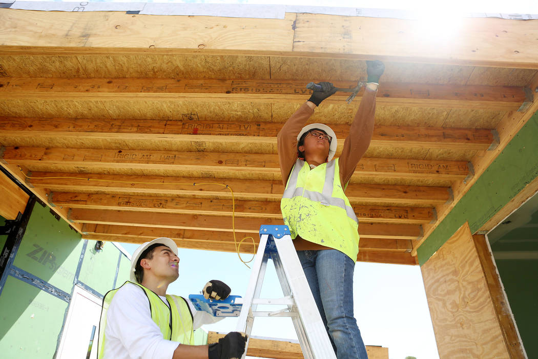 Architecture students Landon Baker, left, and Abbey Escala work on a solar-powered house which UNLV students design and build on UNLV's Paradise Campus in Las Vegas, Tuesday, Aug. 29, 2017. The UN ...